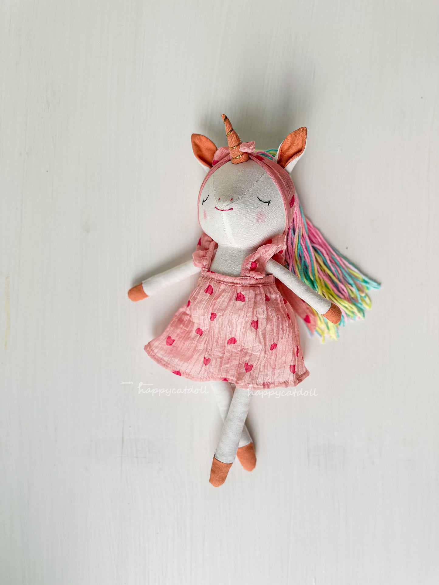 Unicorn doll with pink hearts dress