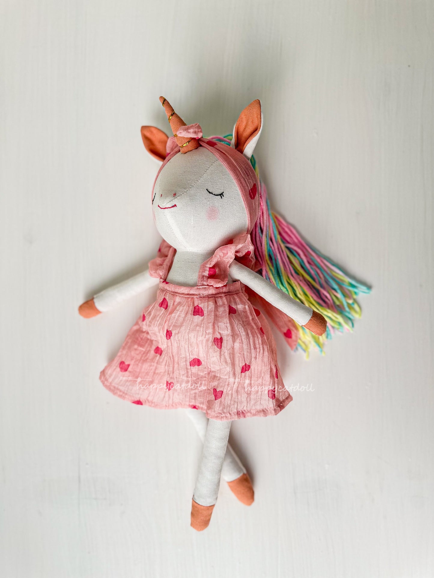 Unicorn doll with pink hearts dress