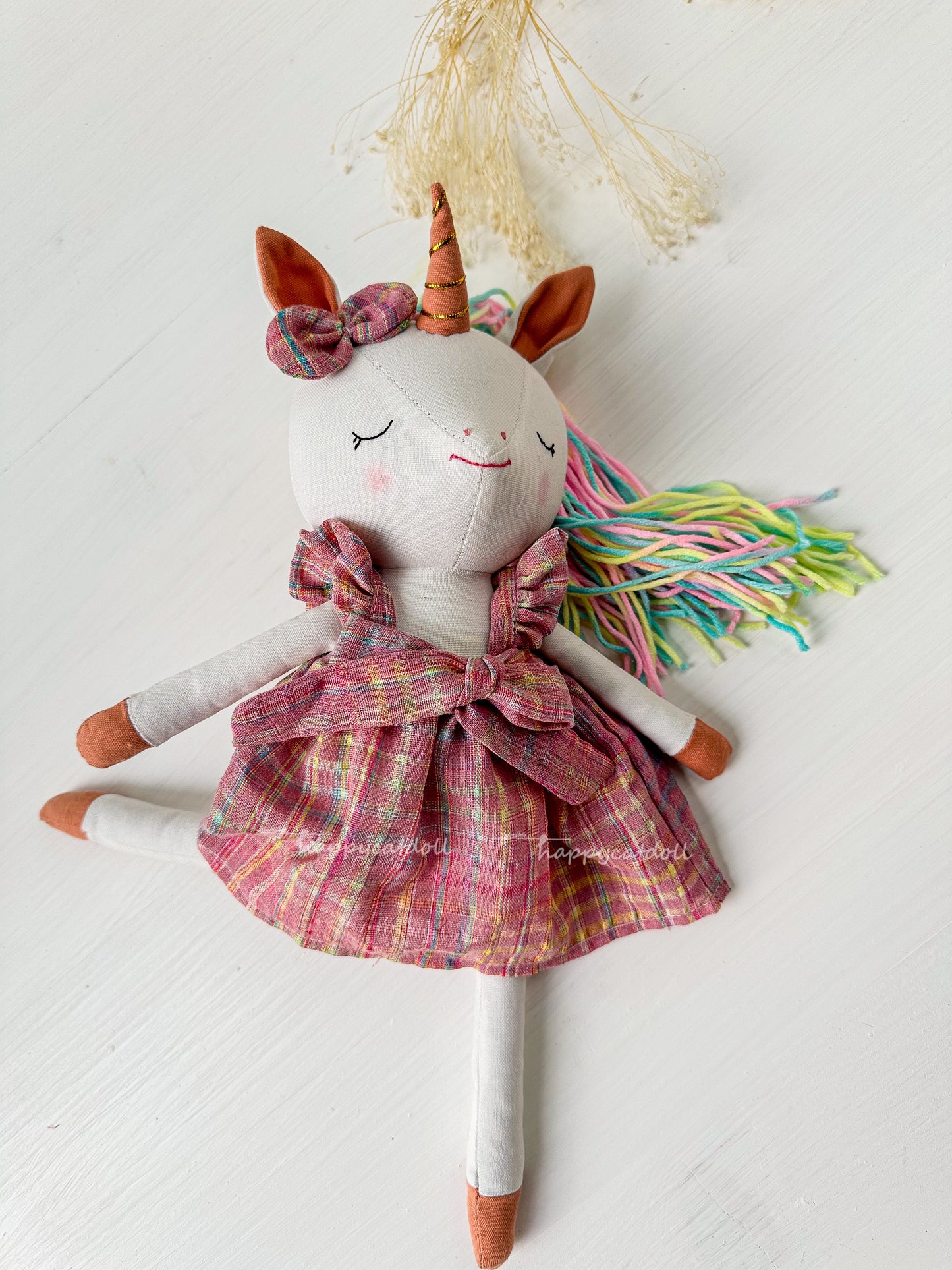 Unicorn with pink checkered dress