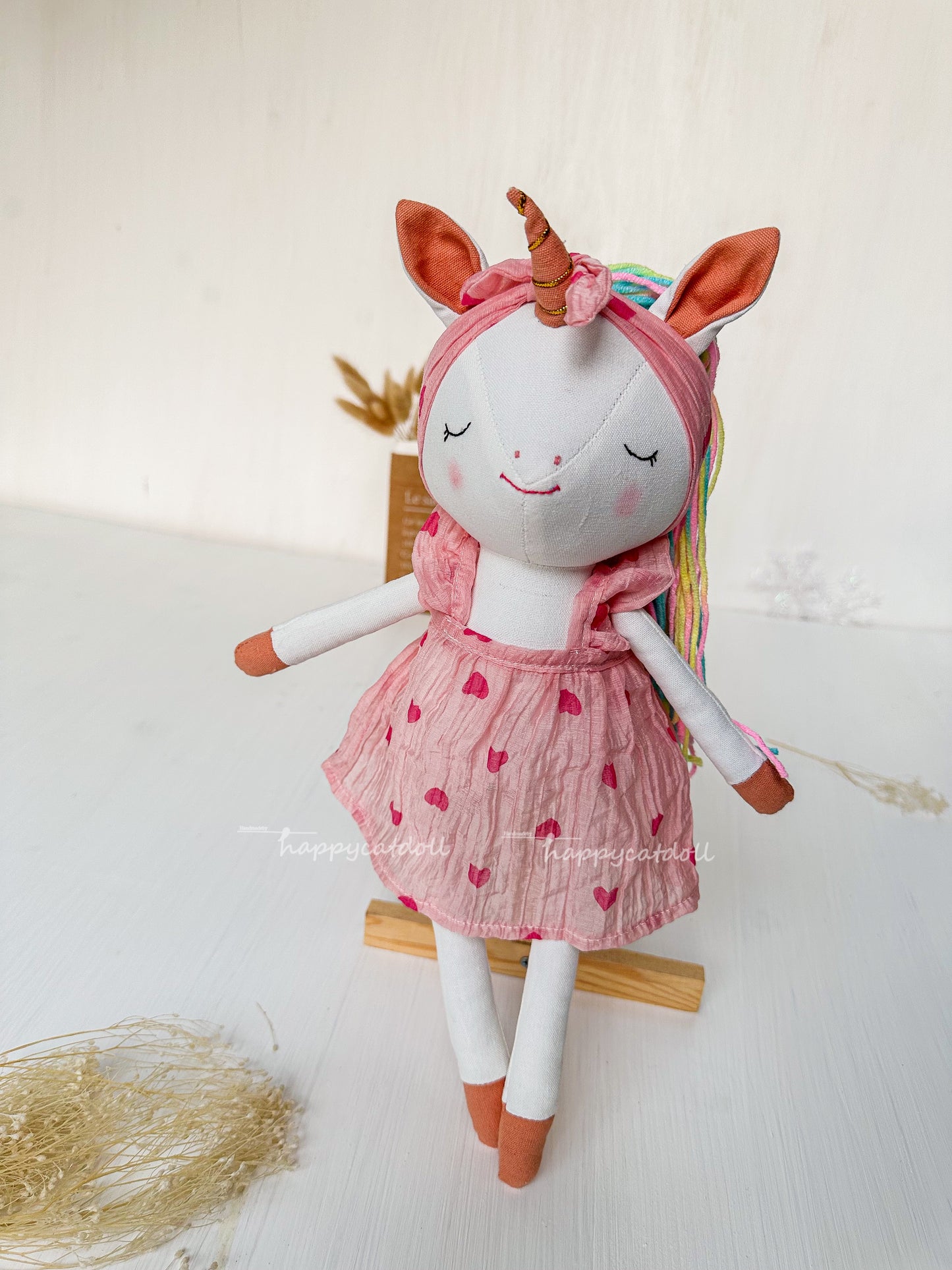 Unicorn doll with pink hearts dress